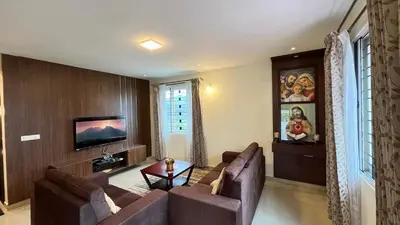 a living room with two couches and a tv at Away From Home - 7 - Home Stay Ooty, Entire 3BHK Villa in Ooty