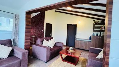 a living room with two purple chairs and a table at Away From Home - 7 - Home Stay Ooty, Entire 3BHK Villa in Ooty