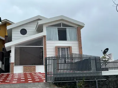a white house with a fence in front of it at Away From Home - 7 - Home Stay Ooty, Entire 3BHK Villa in Ooty