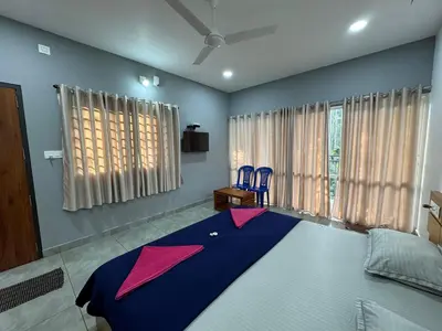 a bedroom with a large bed with kites on it at Himadri Retreat Wayanad in Kaniyāmbetta
