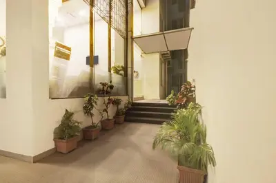 a hallway with potted plants in a building at Townhouse Oak Mysuru Railway Museum in Mysore