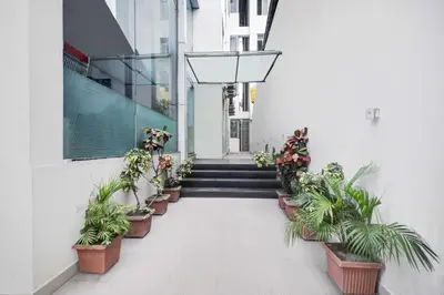 a hallway with potted plants on the side of a building at Townhouse Oak Mysuru Railway Museum in Mysore