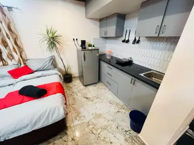 a small kitchen with a bed and a sink at City home-SGH in Mysore