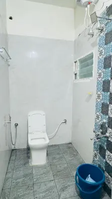 a bathroom with a toilet and a shower at City home-SGH in Mysore