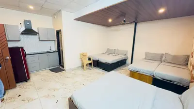 a room with two beds and a kitchen in it at City home-SGH in Mysore