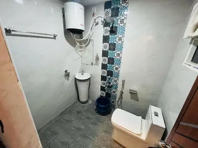 a small bathroom with a toilet and a sink at City home-SGH in Mysore