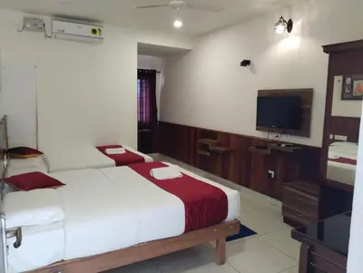 a bedroom with a bed and a flat screen tv at sree ganesh inn in Palani