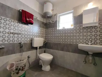 a bathroom with a toilet and a sink at shambhala homestay in Ooty