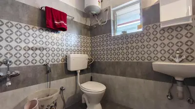 a bathroom with a toilet and a sink at shambhala homestay in Ooty