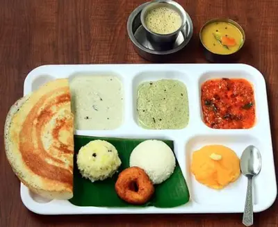 a white tray of food with different types of food at Le Royal Suite in Udumalaippettai