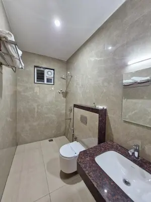 a bathroom with a toilet and a sink at Le Royal Suite in Udumalaippettai