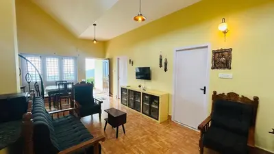 a living room with a couch and a table at Away From Home - 1 - Home Stay Ooty, Entire 3BHK Villa in Ooty