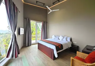 a bedroom with a bed and a large window at Ibex Resorts, Coonoor - Tapas in Yedapalli