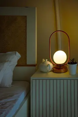 a lamp sitting on a table next to a bed at Cocoon-coxcargill in Vattavada