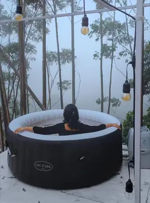 a woman is sitting in a jacuzzi tub at Cocoon-coxcargill in Vattavada
