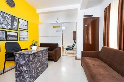 a living room with a couch and a table at Holiday Homes Aluva in Alwaye