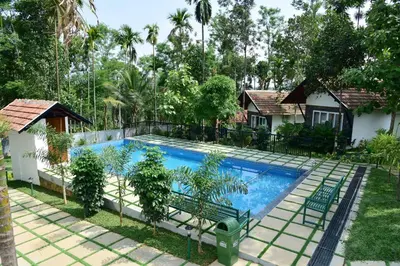 an image of a swimming pool in a resort at Snow White Wayanad in Wayanad