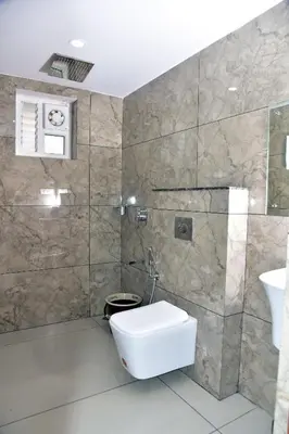 a bathroom with a toilet and a sink at Snow White Wayanad in Wayanad