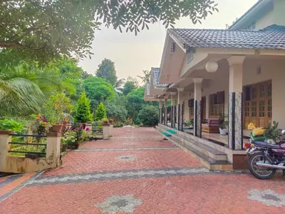 a red brick walkway next to a building at Jacob's Homestay in Wayanad