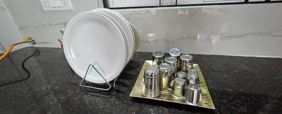 a bunch of silver containers on a tray next to a mixer at Premium Service apartment in Mysore