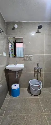 a bathroom with a sink and a toilet at Premium Service apartment in Mysore