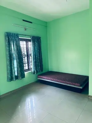 a room with a bench in a room with a window at EV7 Stays in Trichūr