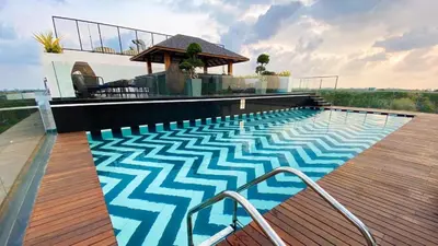 a swimming pool on a deck with a gazebo at 2BR Flat with Pool and Balcony near Cochin Airport in Cochin