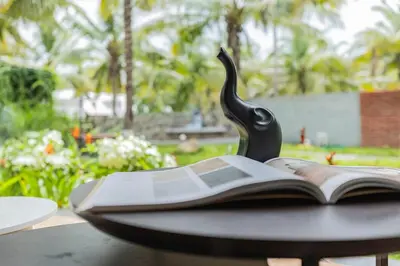 a book with a black handle sitting on a table at Ekta Pool Farmstay Pollachi in Pollāchi