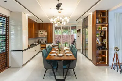 a kitchen and dining room with a table and chairs at Ekta Pool Farmstay Pollachi in Pollāchi