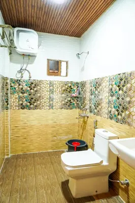 a bathroom with a toilet and a shower at Le Karaj Meadows in Lovedale