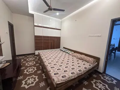 a bedroom with a bed and a ceiling fan at Kanchana Sirur home in Coimbatore