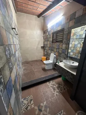 a bathroom with a toilet and a sink at Kanchana Sirur home in Coimbatore