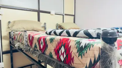 a room with two beds with christmas blankets at Mysuru dorm-sgh in Mysore