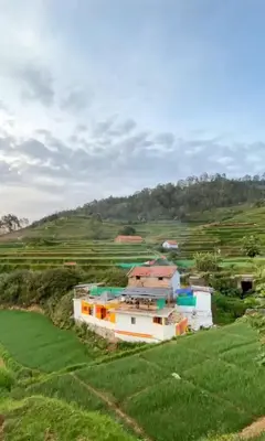 an aerial view of a house in a green field at Muffintrip stays camp N trek in Kūkkāl