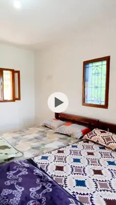 a bedroom with a bed with a lamp on it at Muffintrip stays camp N trek in Kūkkāl