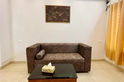 a living room with a couch and a table at Nestora Suites in Kozhikode