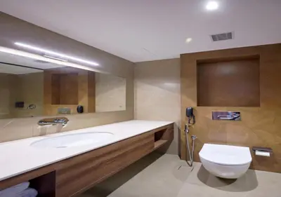 a bathroom with a sink and a toilet and a phone at REGAL HEIGHTS in Ernakulam