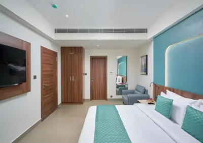 a hotel room with a bed and a tv at REGAL HEIGHTS in Ernakulam