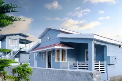 a blue house with a white at TJH Mountain View 4 bhk Villa - Family Haven! in Kodaikānāl