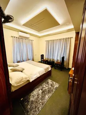 a bedroom with a bed and a room with at Executive Room in Kelakam