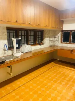 a kitchen with a sink and a counter top at Executive Room in Kelakam