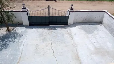 a gate on the top of a concrete ramp at The Good Shepherd Cottage in Pollāchi