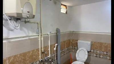 a bathroom with a toilet and a shower stall at The Good Shepherd Cottage in Pollāchi