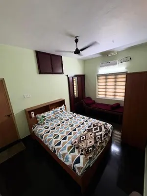 a bedroom with a bed and a ceiling at Cloud Nine Home Thrissur in Trichūr