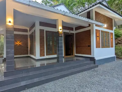a small house with a porch at DreamWoods Cottage in Kelakam