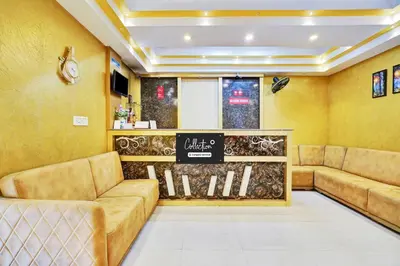a waiting room with couches and a sign on the wall at Hotel O Kushal Nagar Near KSRTC Bus Stand in Kushālnagar