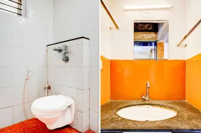 a bathroom with a toilet and a sink at Hotel O Mysuru Sand Museum in Mysore