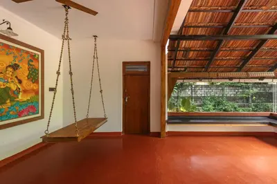 an empty room with a swing and a window at The Oneness Living- Seasonal Heritage stay with Tholpaavakoothu nights in Pazhayannūr