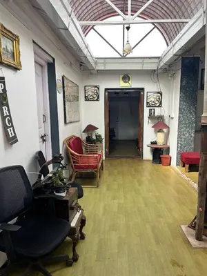an office with a room with chairs and a hallway at Bykerstops in Ooty