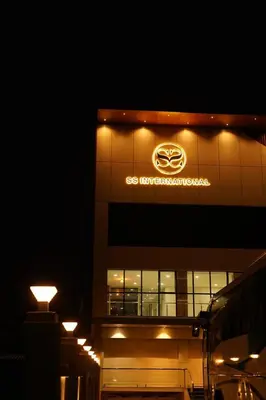 a building with acedes benz sign on the side of it at Hotel S S International Coorg in Suntikoppa